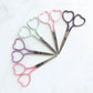 Embroidery scissors in multiple colors with heart shaped finger holes