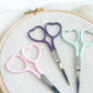 Embroidery scissors in multiple colors with heart shaped finger holes