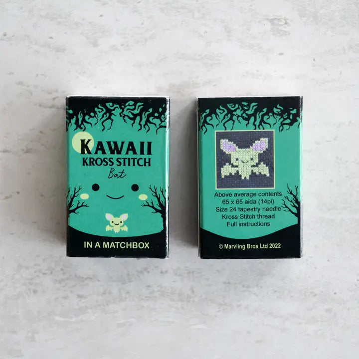Two Kawaii Kross Stitch matchbox packaging on a light gray background