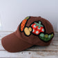Brown cap with vegetable patches on a wooden surface