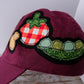 Maroon cap with tomato, mushrooms, and pea patch on a white background