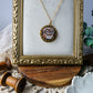 Necklace with a heart pendant in a gold frame on a textured surface