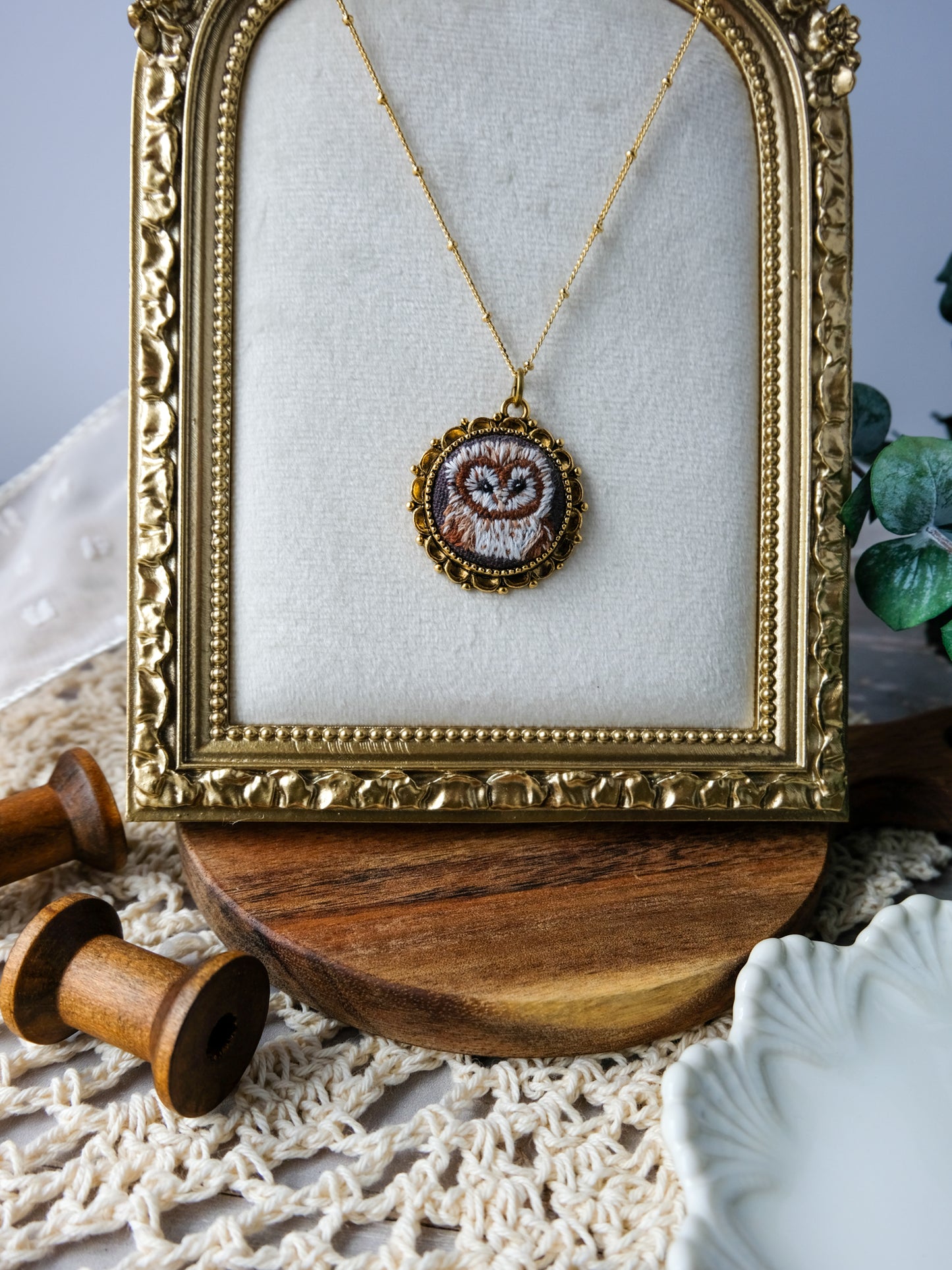 Necklace with a heart pendant in a gold frame on a textured surface