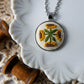 Necklace with embroidered pendant on a decorative plate